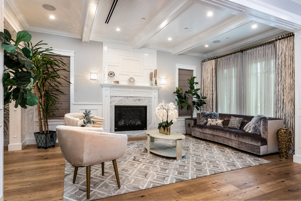 Design ideas for a classic formal open plan living room in Los Angeles with grey walls, medium hardwood flooring, a standard fireplace and beige floors.