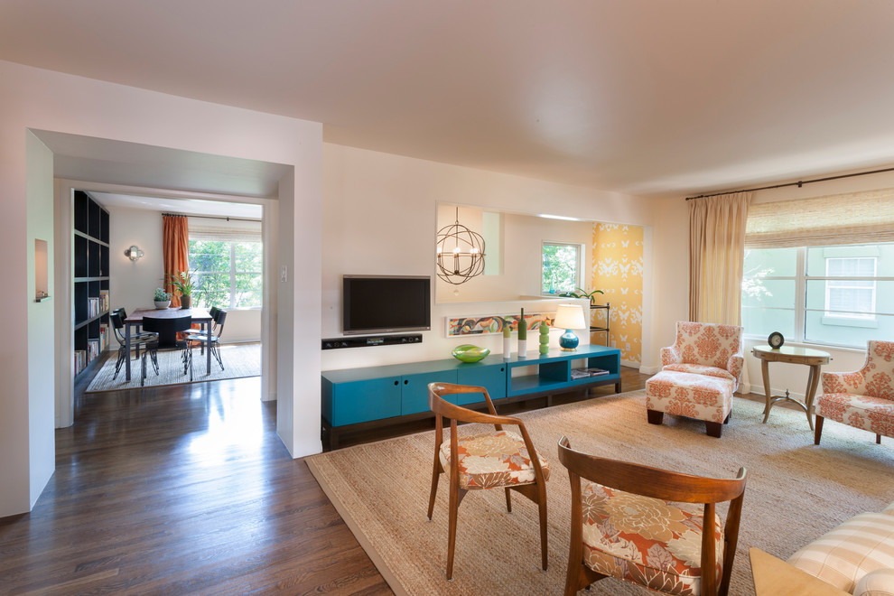 Inspiration for a modern living room remodel in Austin with white walls and a wall-mounted tv
