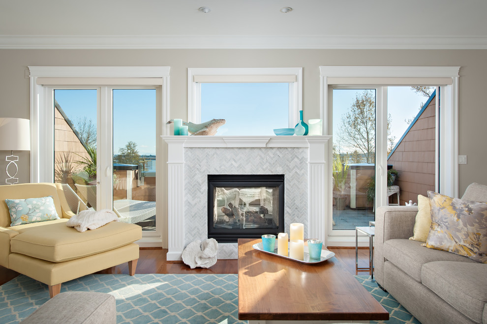 Beach style open plan living room in Vancouver with a two-sided fireplace, a stone fireplace surround and a wall mounted tv.