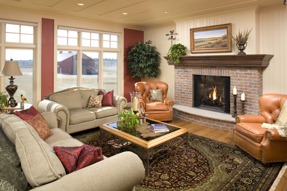 Photo of a large farmhouse formal open plan living room in Minneapolis with a standard fireplace, a brick fireplace surround, beige walls, medium hardwood flooring and no tv.