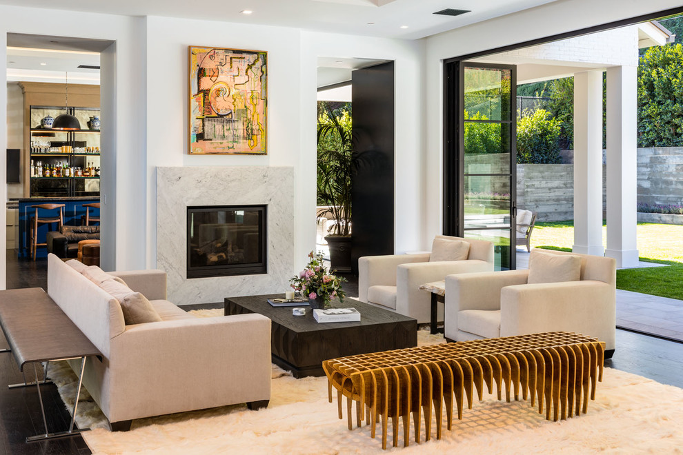 Photo of a large contemporary formal open plan living room in Los Angeles with white walls, a standard fireplace, a stone fireplace surround, dark hardwood flooring, no tv and brown floors.
