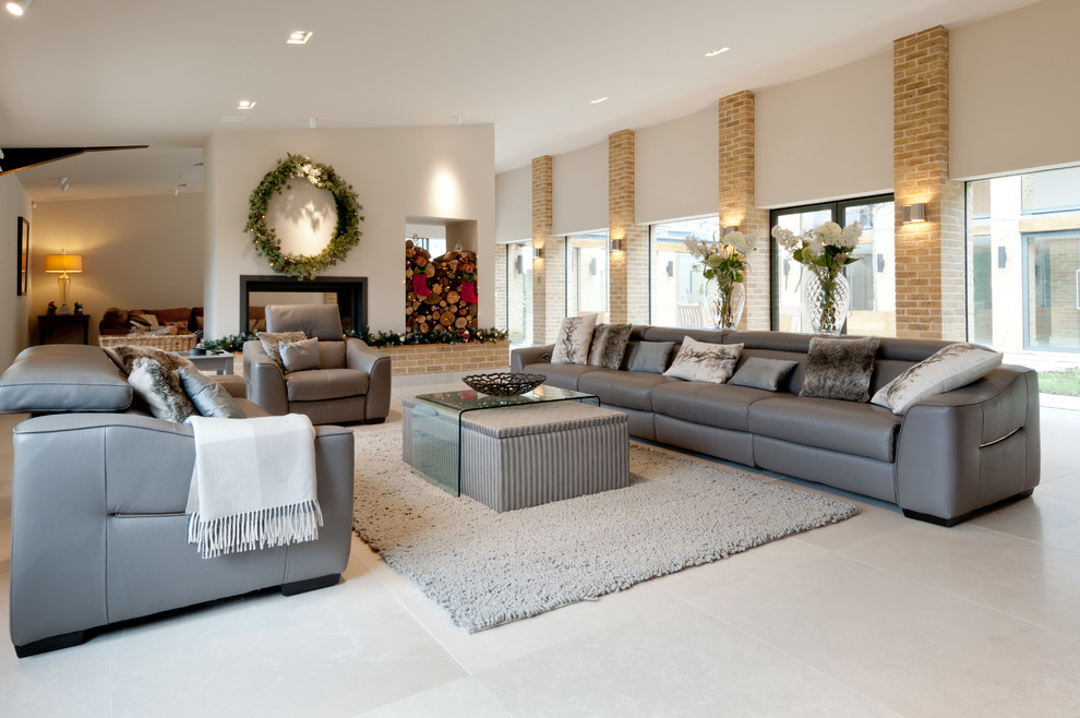 Photo of a contemporary living room in Kent with limestone flooring.