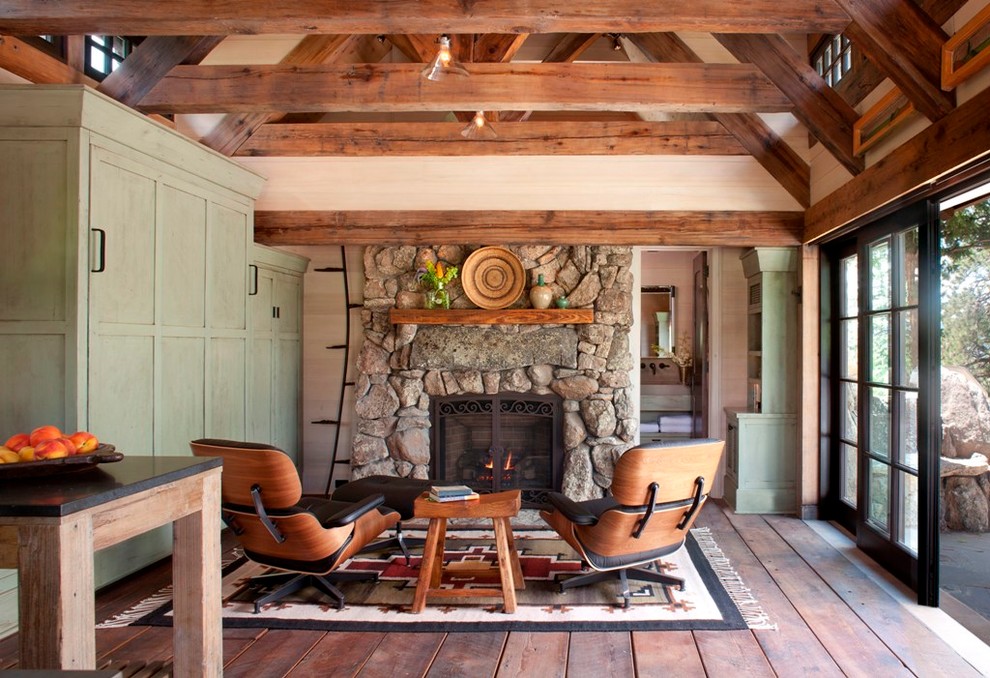 Living room - small rustic open concept medium tone wood floor living room idea in Denver with a stone fireplace, multicolored walls and a standard fireplace