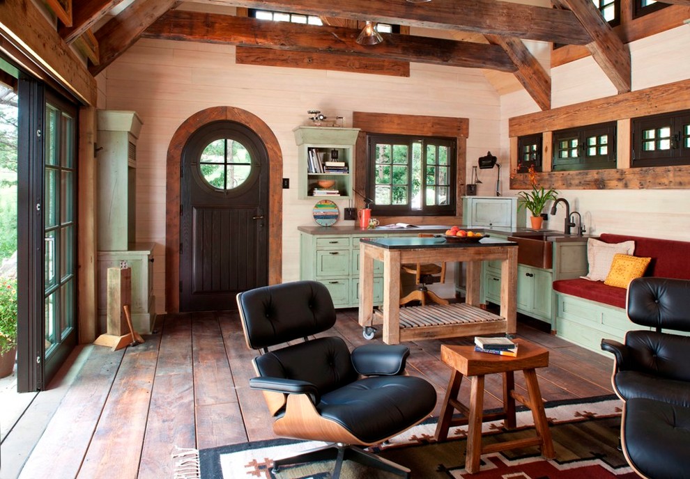 Example of a small mountain style open concept medium tone wood floor living room design in Denver with beige walls