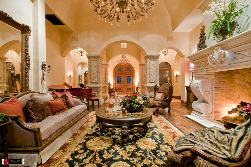 Living room - large mediterranean formal and enclosed medium tone wood floor living room idea in Phoenix with beige walls, a standard fireplace, a stone fireplace and no tv