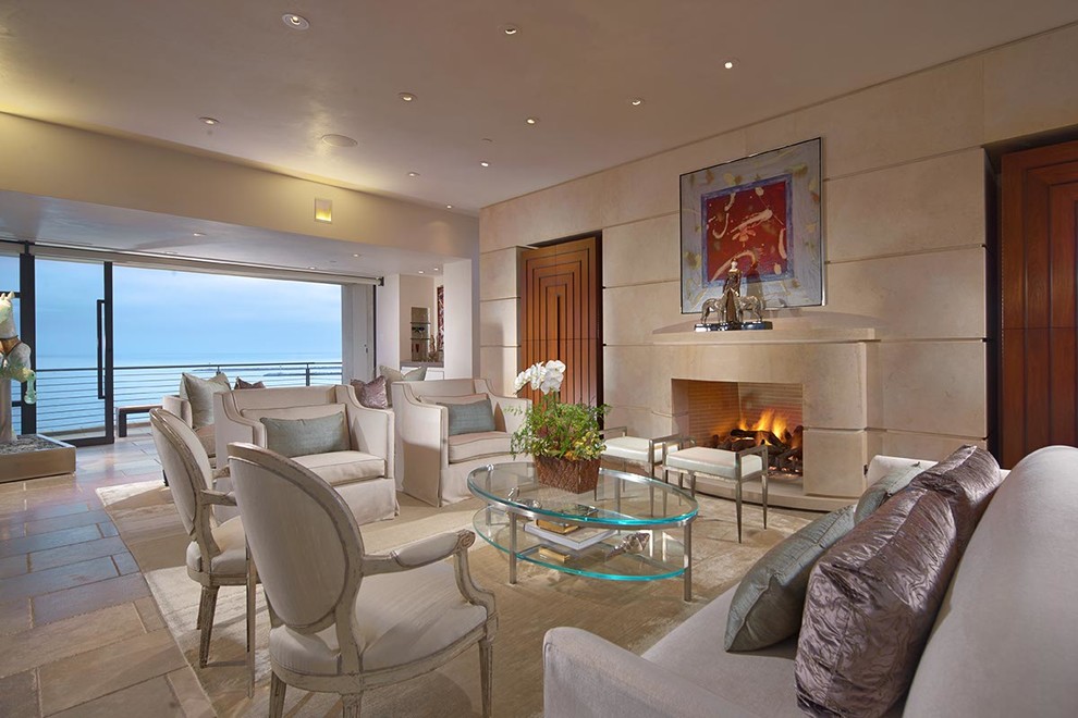 This is an example of a large contemporary formal mezzanine living room in Los Angeles with beige walls, limestone flooring, a standard fireplace, a stone fireplace surround and no tv.