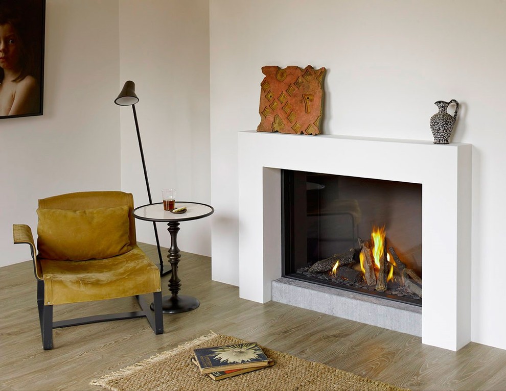 This is an example of a contemporary living room in Hampshire with a standard fireplace and a stone fireplace surround.
