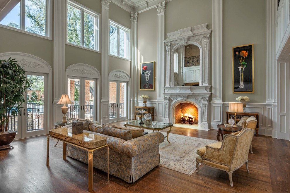 Inspiration for a large timeless formal and enclosed dark wood floor living room remodel in Dallas with beige walls, a standard fireplace, a plaster fireplace and no tv