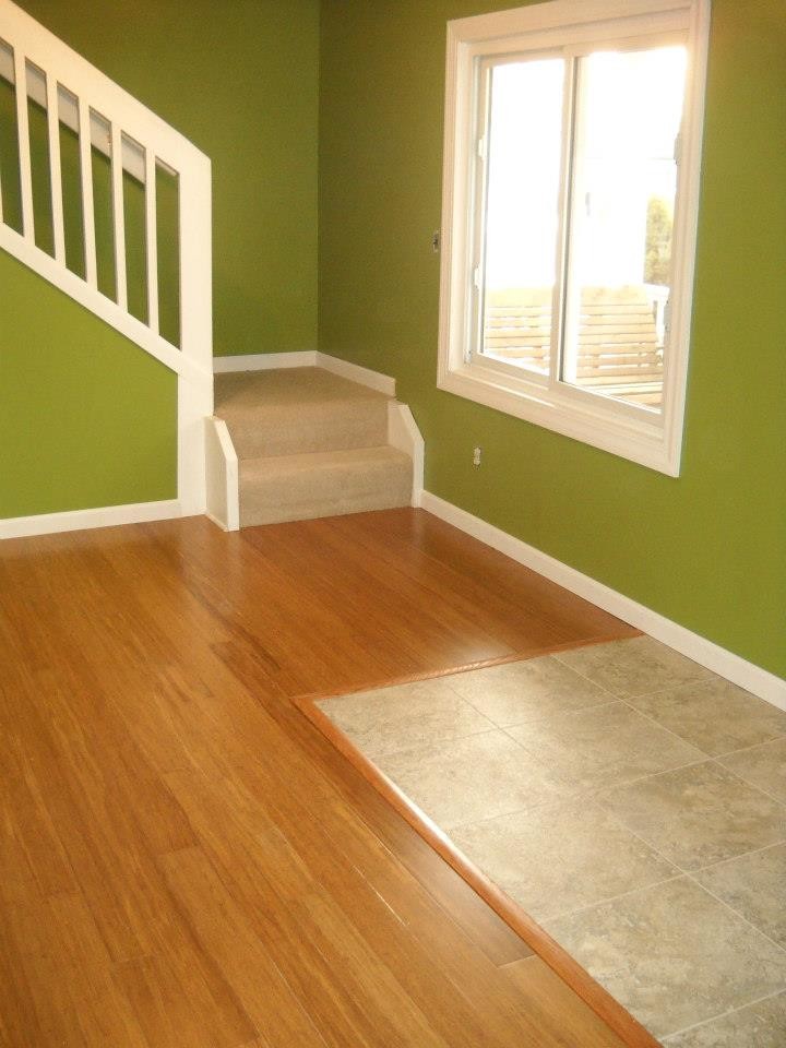 Example of a mid-sized classic open concept bamboo floor living room design in Detroit with green walls, no fireplace and no tv