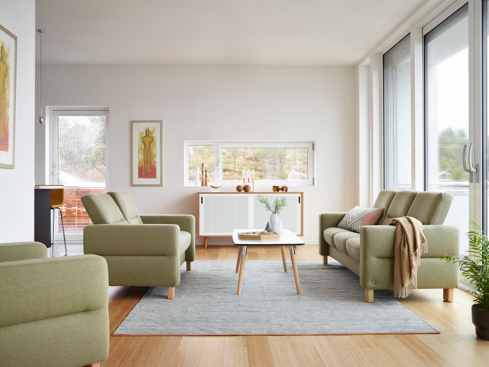 This is an example of a medium sized midcentury formal open plan living room in Milwaukee with white walls, light hardwood flooring, no fireplace, no tv and beige floors.