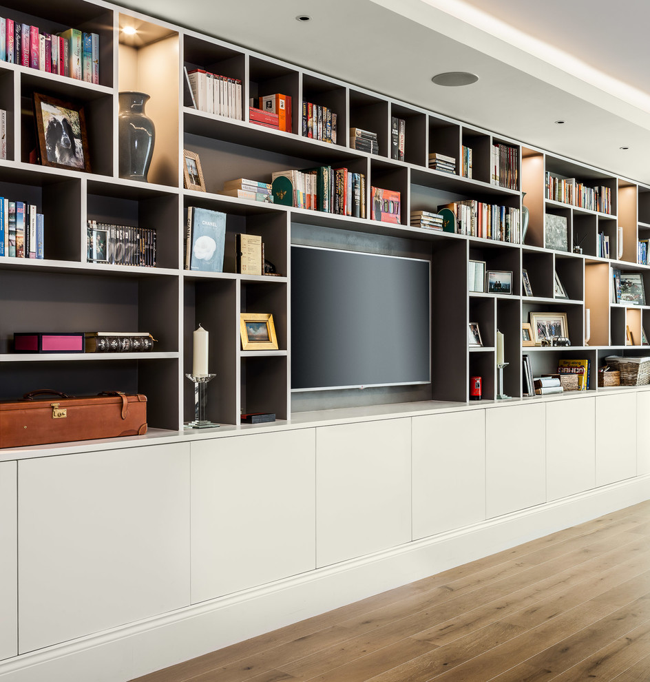 Photo of a medium sized classic living room in London with grey walls, medium hardwood flooring and a wall mounted tv.