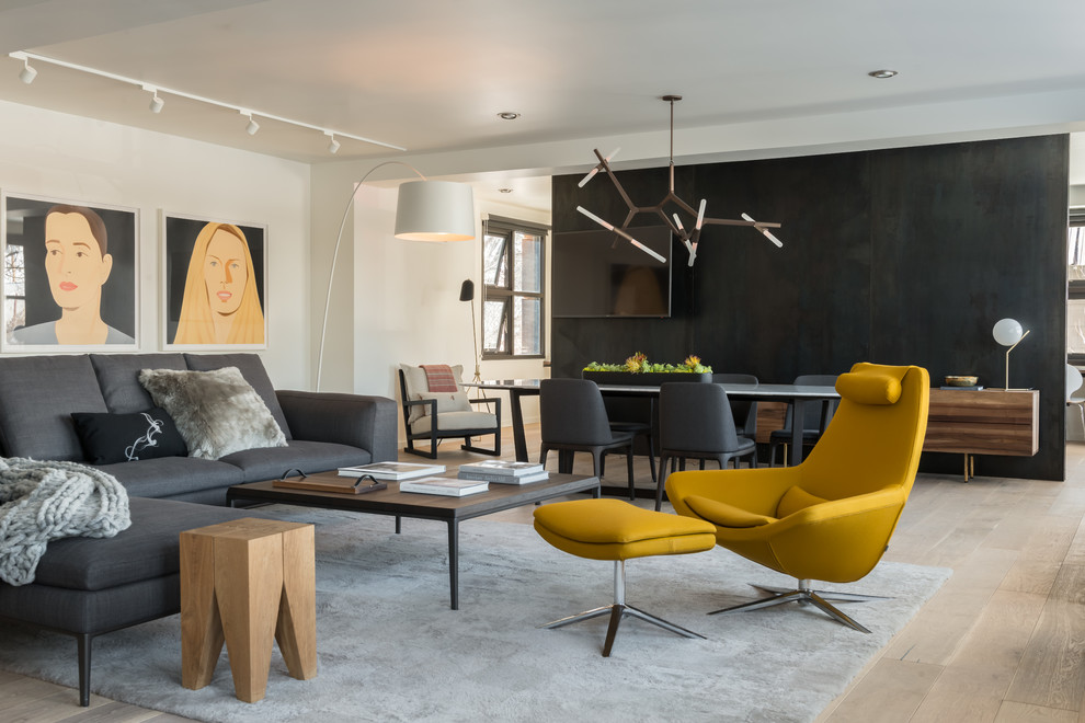 This is an example of a contemporary grey and yellow open plan living room in Other with black walls, medium hardwood flooring and brown floors.