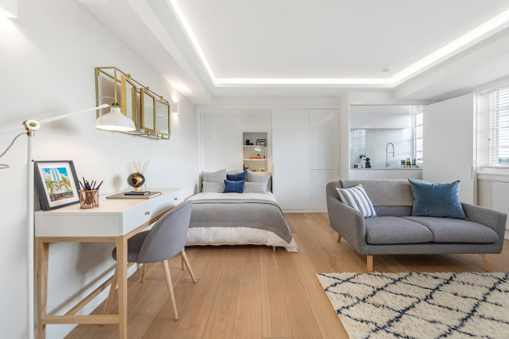 Medium sized scandi open plan living room in London with white walls and brown floors.