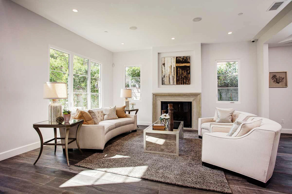 Inspiration for a mediterranean living room in Los Angeles with white walls and dark hardwood flooring.
