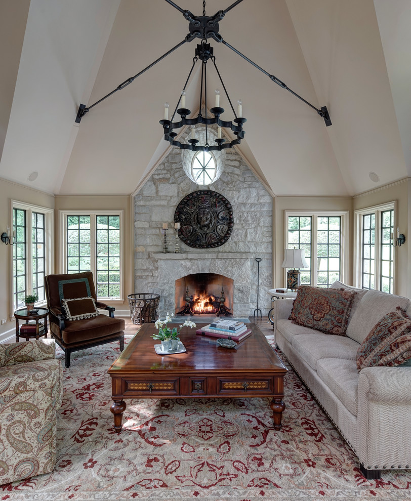 Living room - mid-sized traditional formal and enclosed carpeted living room idea in Chicago with beige walls, a standard fireplace, a stone fireplace and no tv