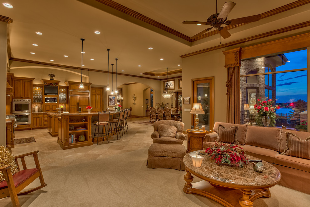 Large classic formal open plan living room in Omaha with brown walls, carpet, a freestanding tv, a standard fireplace, a stone fireplace surround and beige floors.