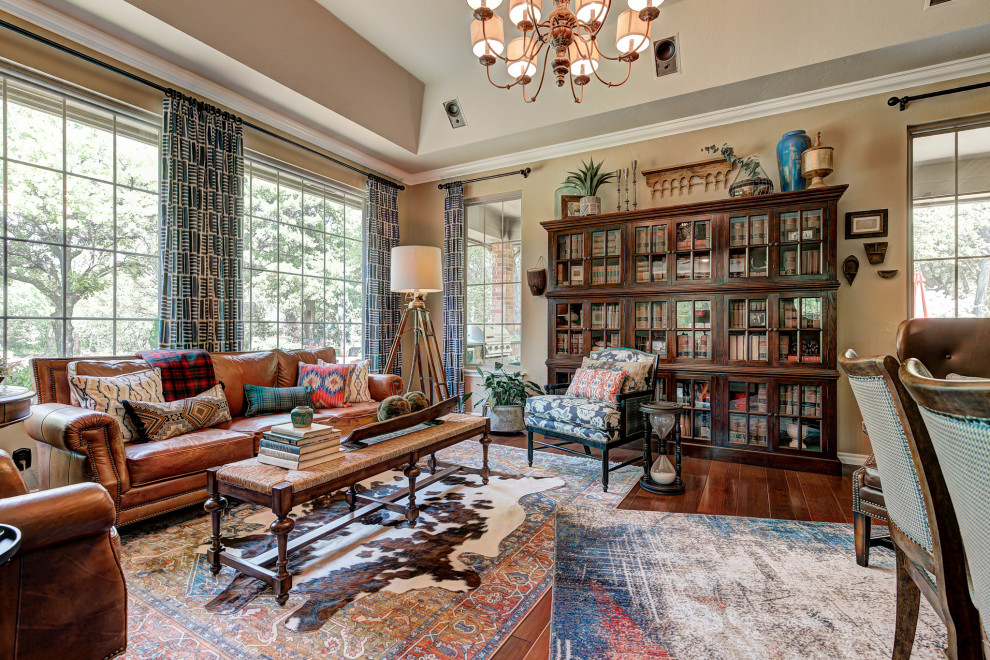 Bohemian living room in Oklahoma City with brown walls, dark hardwood flooring, brown floors and a vaulted ceiling.