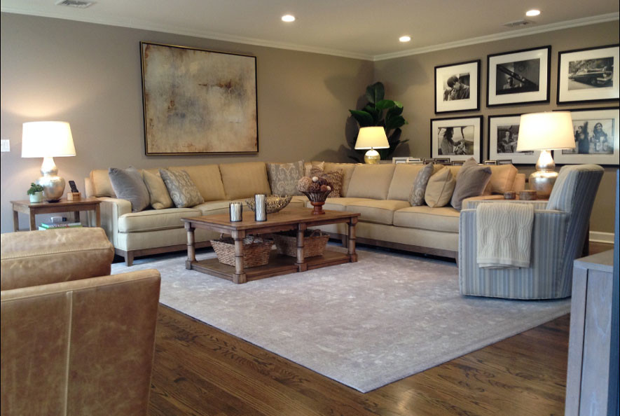 Photo of a large rustic formal enclosed living room in New York with grey walls, medium hardwood flooring, a standard fireplace, a stone fireplace surround, no tv and brown floors.