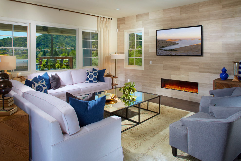 This is an example of a large traditional open plan living room in San Francisco with beige walls, dark hardwood flooring, a standard fireplace, a wooden fireplace surround and a wall mounted tv.