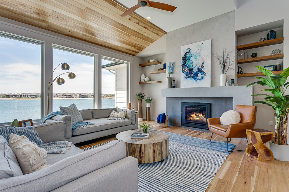 Inspiration for a beach style living room in Wichita with grey walls, light hardwood flooring and a standard fireplace.