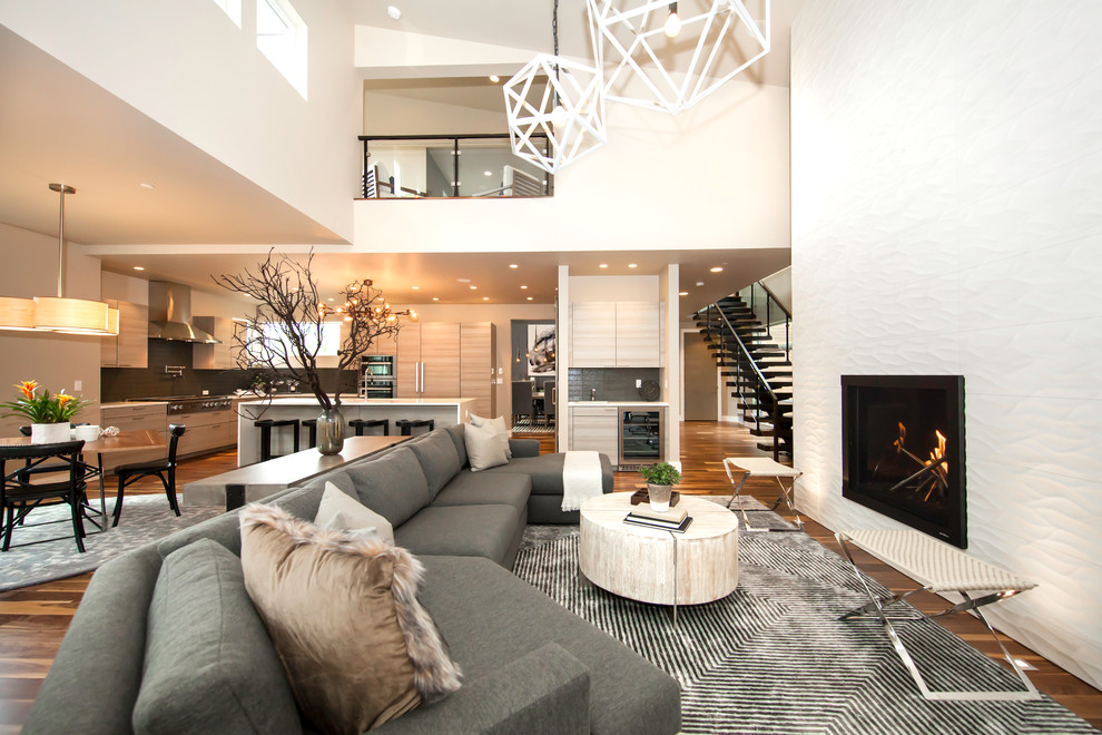 Example of a trendy open concept dark wood floor living room design in Denver with white walls, a ribbon fireplace and no tv