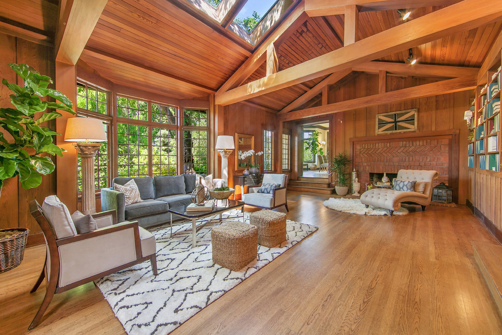 Inspiration for a large timeless formal and open concept medium tone wood floor and brown floor living room remodel in San Francisco with a standard fireplace, a brick fireplace, brown walls and no tv