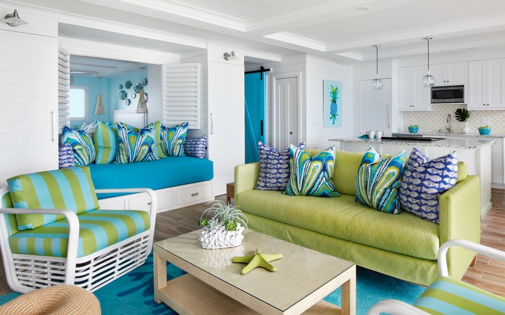 Photo of a nautical open plan living room in Hawaii with white walls, medium hardwood flooring and brown floors.