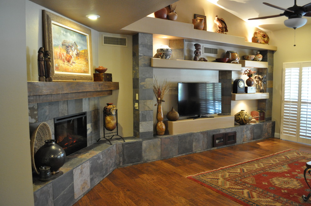 Example of a mid-sized southwest open concept and formal dark wood floor and brown floor living room design in Phoenix with beige walls, a corner fireplace, a stone fireplace and a tv stand