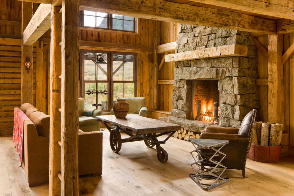 This is an example of a rustic living room in Other with a standard fireplace and a stone fireplace surround.