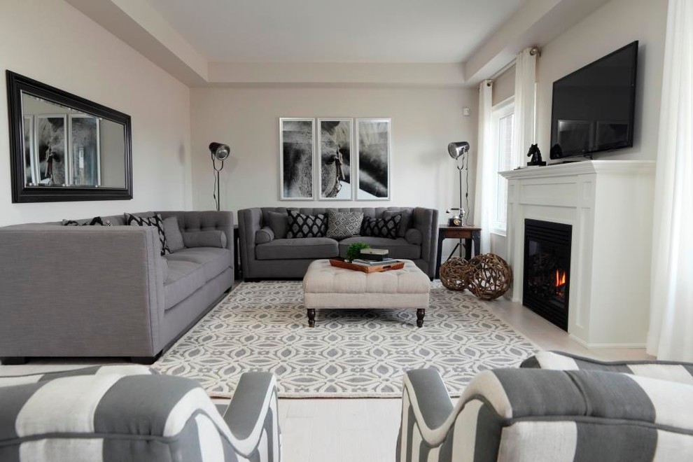 Diseño de salón gris y blanco actual con paredes blancas, todas las chimeneas y televisor colgado en la pared