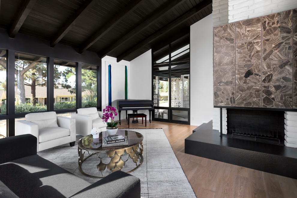 Inspiration for a large midcentury formal open plan living room in Orange County with white walls, light hardwood flooring, a corner fireplace, a stone fireplace surround, no tv and beige floors.