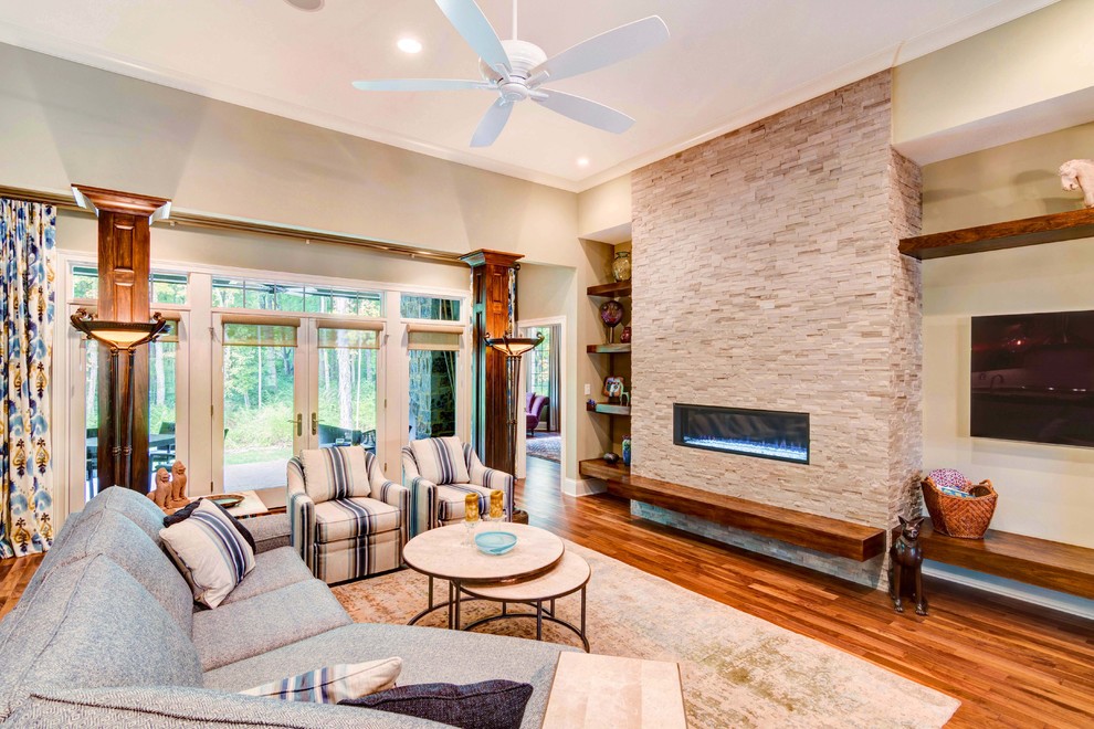 This is an example of a medium sized classic formal open plan living room in Indianapolis with beige walls, a ribbon fireplace, brown floors, dark hardwood flooring, a stone fireplace surround and no tv.