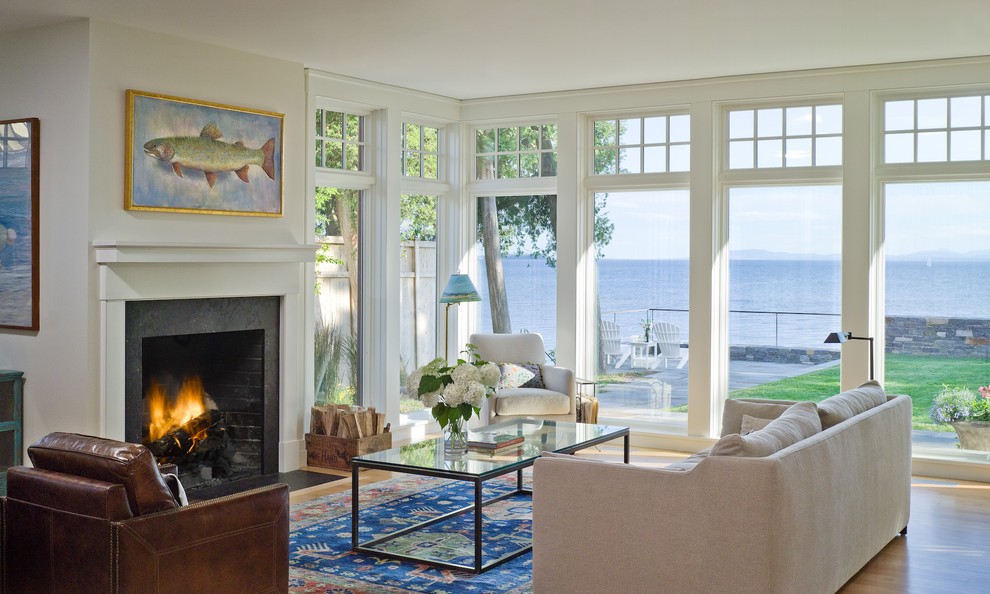 Example of a mid-sized classic open concept light wood floor living room design in Burlington with white walls, a standard fireplace, no tv and a stone fireplace