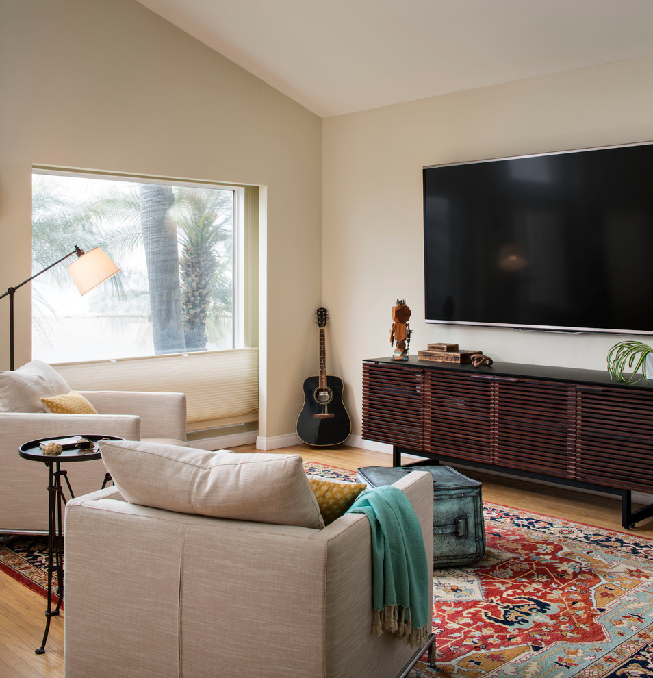This is an example of a medium sized modern open plan living room in San Francisco with light hardwood flooring, no fireplace, a music area, beige walls and a wall mounted tv.