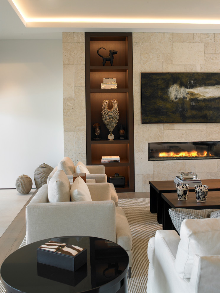 Inspiration pour un salon design avec une salle de réception, un mur beige, une cheminée ribbon et un manteau de cheminée en carrelage.