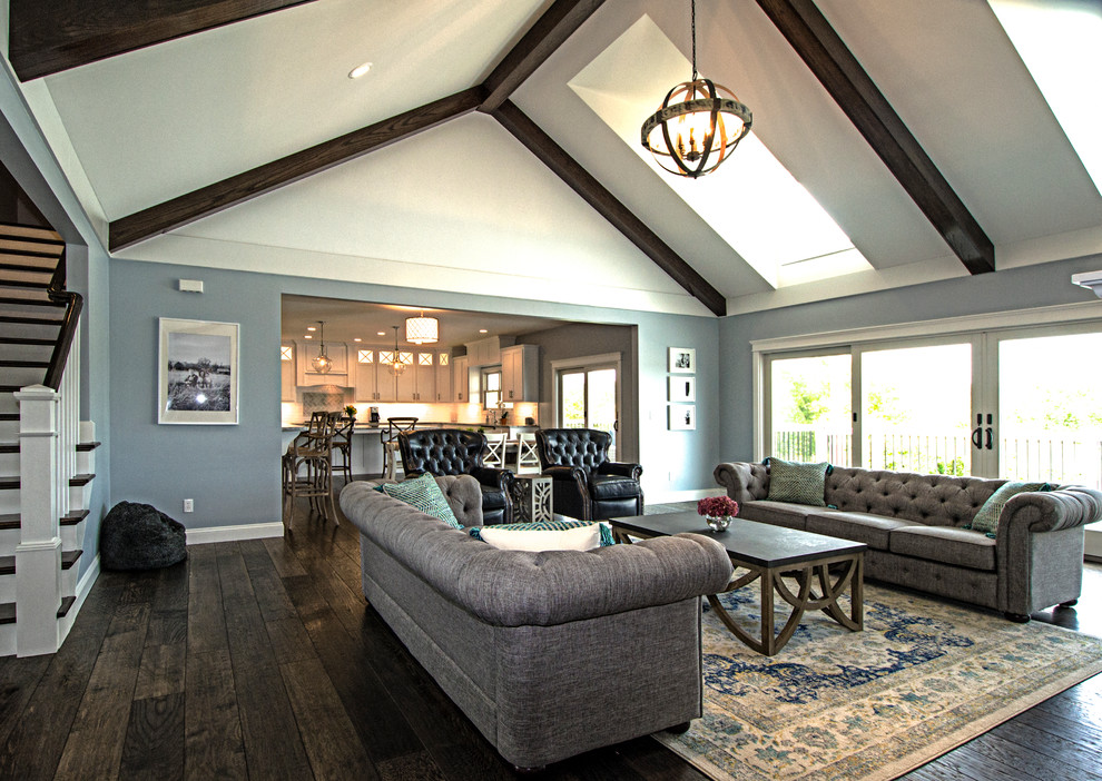 Example of a mid-sized classic formal and enclosed dark wood floor and brown floor living room design in St Louis with gray walls, a standard fireplace, a stone fireplace and a wall-mounted tv