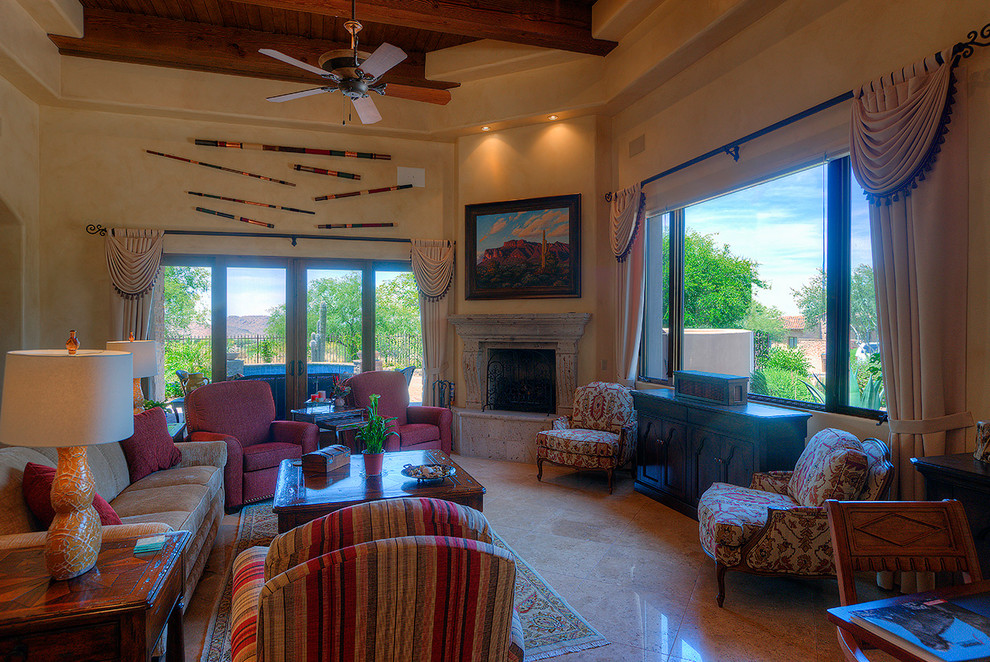 Large southwest open concept travertine floor living room photo in Phoenix with beige walls, a corner fireplace, a stone fireplace and a concealed tv