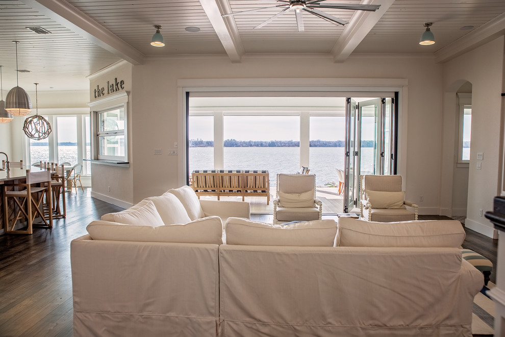 This is an example of a medium sized coastal formal open plan living room in Dallas with white walls, dark hardwood flooring, a ribbon fireplace, a wooden fireplace surround, a concealed tv and brown floors.