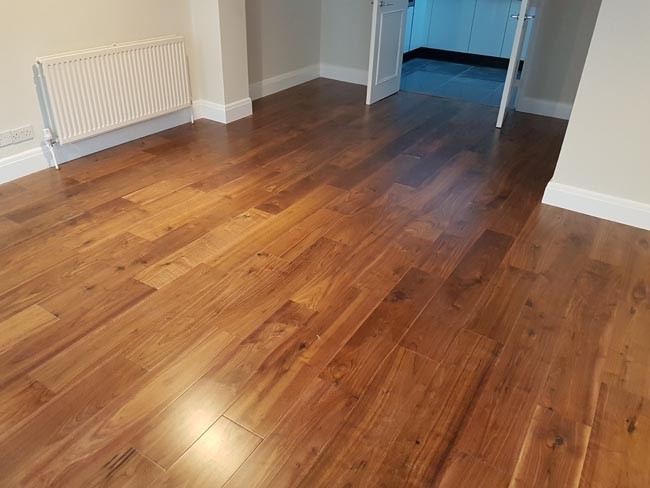 Example of a mid-sized transitional medium tone wood floor living room design in London
