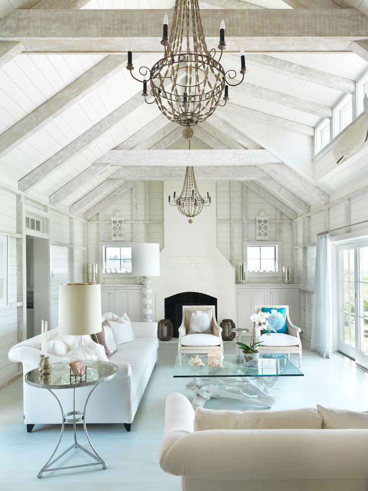 Example of a beach style formal painted wood floor and blue floor living room design in Boston with white walls and a standard fireplace