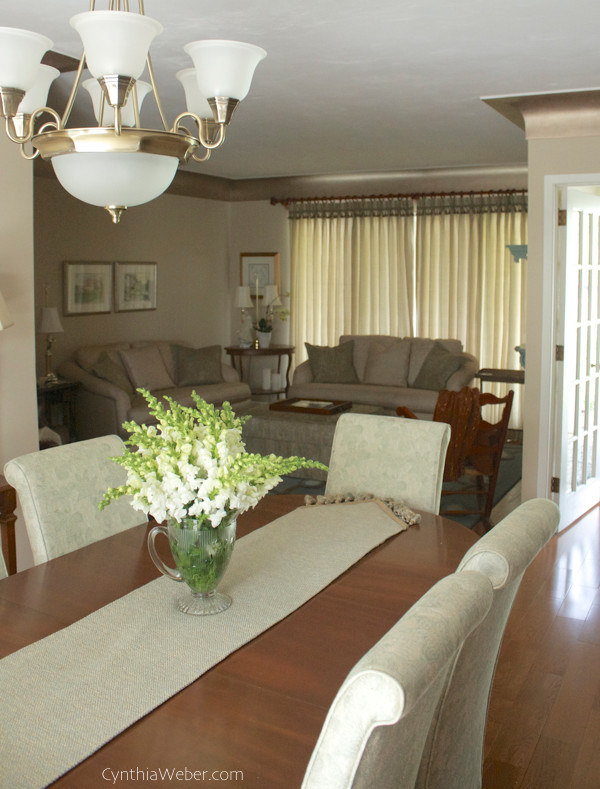 Elegant open concept medium tone wood floor living room photo in Toronto with beige walls