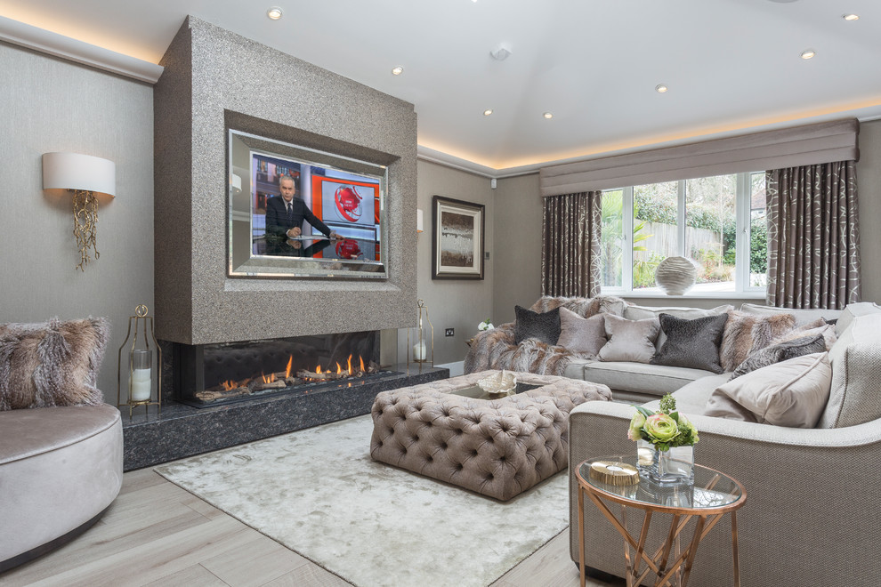 Classic living room in Surrey with beige walls, a ribbon fireplace, a wall mounted tv and beige floors.