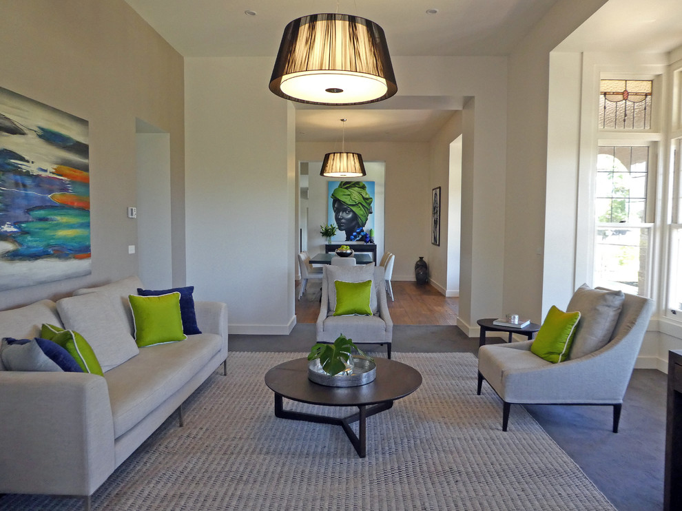 This is an example of a large contemporary formal open plan living room in Melbourne with white walls.