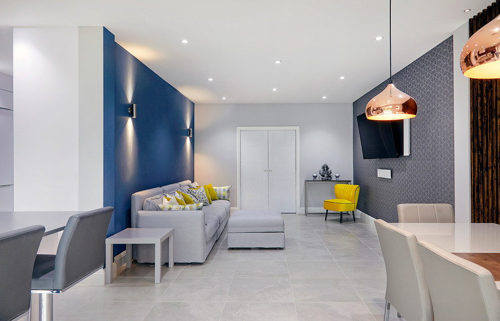 Mid-sized trendy open concept porcelain tile and white floor living room photo in Surrey with blue walls and a wall-mounted tv