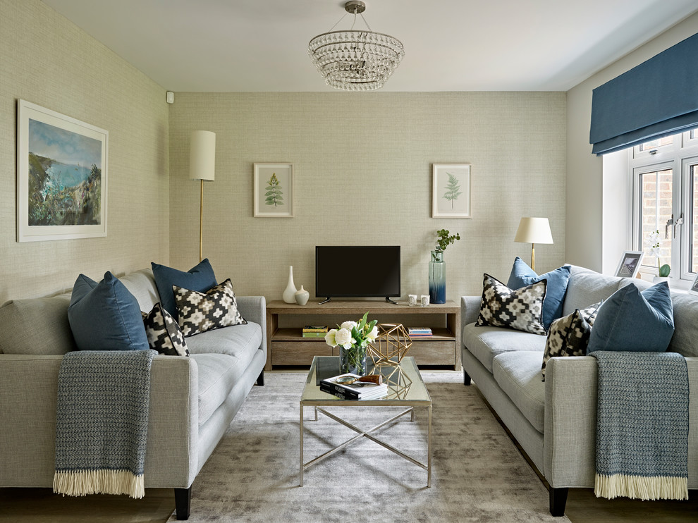 This is an example of a small contemporary enclosed living room in Sussex with grey walls, a freestanding tv and no fireplace.