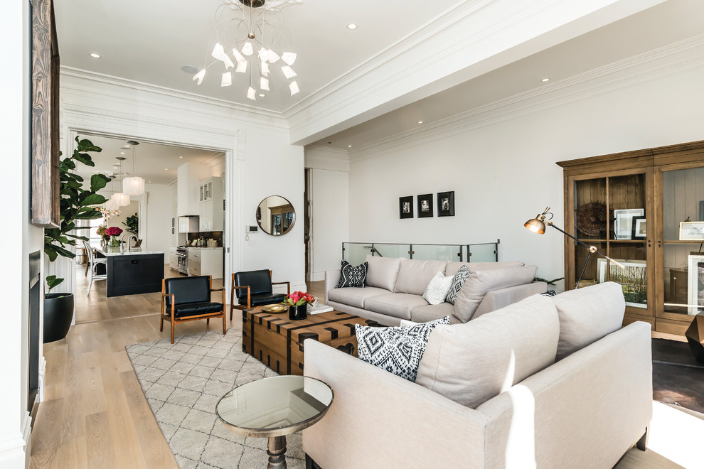 Photo of a classic living room in San Francisco with white walls and light hardwood flooring.