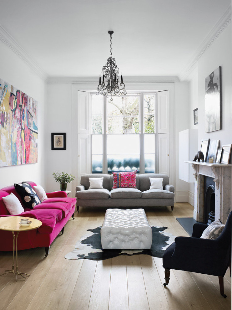 Inspiration for a bohemian formal and grey and black living room in London with white walls, light hardwood flooring, a standard fireplace and beige floors.