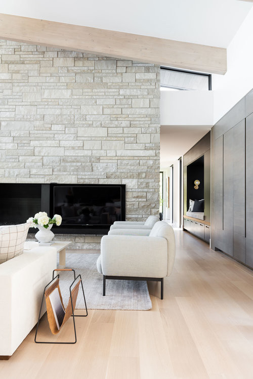 Inspiration for a large modern open concept light wood floor living room remodel in Salt Lake City with white walls, a standard fireplace and a media wall