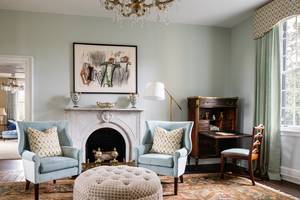 Elegant enclosed living room photo in Other with blue walls and a standard fireplace