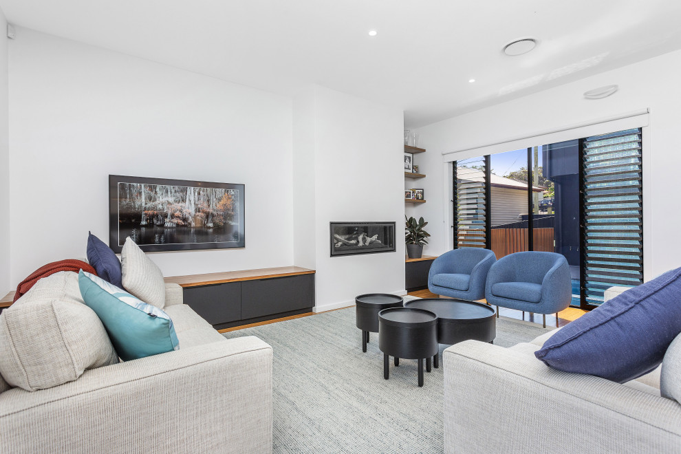 Modernes Wohnzimmer mit weißer Wandfarbe, braunem Holzboden, Gaskamin und braunem Boden in Sydney
